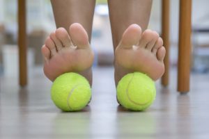 Feet massage of the tennis ball therapy