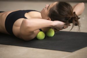 Woman using the tennis ball therapy