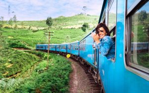 At train station,Young Tourist Girl walking,Dragging luggage suitcase and searching right direction.Asian Backpacker waiting train and planning happy holiday vacation.Travel concept.